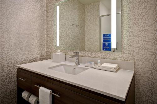 a bathroom with a sink and a mirror at Home2 Suites by Hilton Las Vegas Convention Center - No Resort Fee in Las Vegas