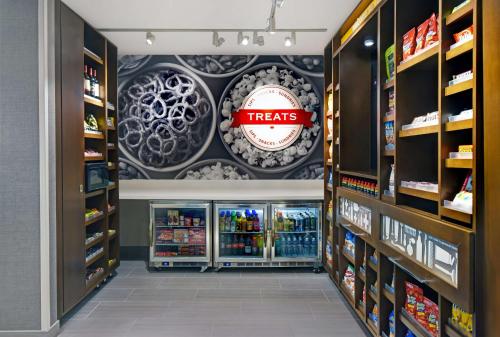 a store aisle with a treats sign on the wall at Hampton Inn Las Vegas Strip South, NV 89123 in Las Vegas