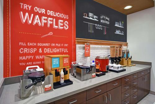 a coffee shop with a sign that says try our delicious waffles at Hampton Inn Las Vegas Strip South, NV 89123 in Las Vegas