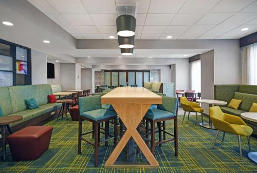 a conference room with tables and chairs and a table at Hampton Inn Las Vegas Strip South, NV 89123 in Las Vegas