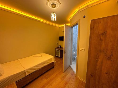 a bedroom with a bed and a door to a bathroom at pilot hotel in Arnavutköy