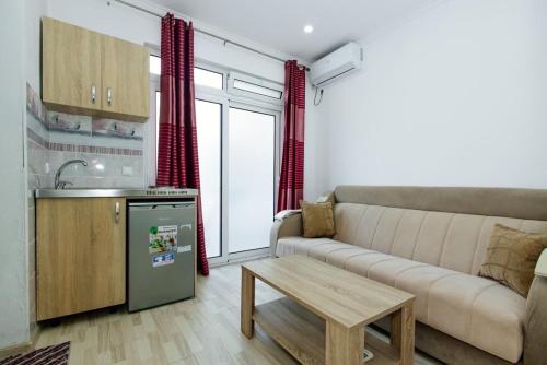 a living room with a couch and a table at Flori Apartments in Ulcinj