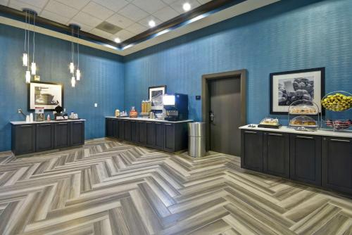 a room with blue walls and wooden floors and counters at Hampton Inn & Suites Los Angeles Burbank Airport in Burbank