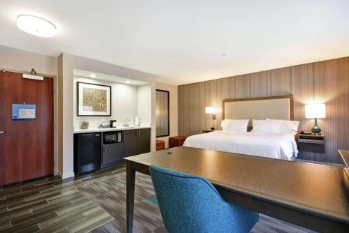 Cette chambre comprend un lit et un bureau. dans l'établissement Hampton Inn & Suites Los Angeles Burbank Airport, à Burbank