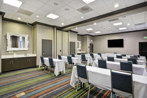 a conference room with tables and chairs and a tv at Hampton Inn & Suites Los Angeles Burbank Airport in Burbank
