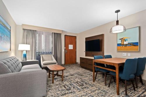 a living room with a couch and a table at Embassy Suites by Hilton Anaheim South in Anaheim