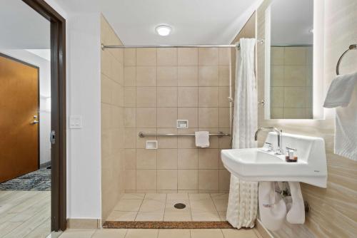 a bathroom with a sink and a shower at Embassy Suites by Hilton Anaheim South in Anaheim