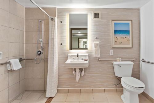 a bathroom with a sink and a toilet at Embassy Suites by Hilton Anaheim South in Anaheim