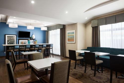 a restaurant with tables and chairs and a couch at Hampton Inn Los Angeles Int'l Airport/Hawthorne in Los Angeles