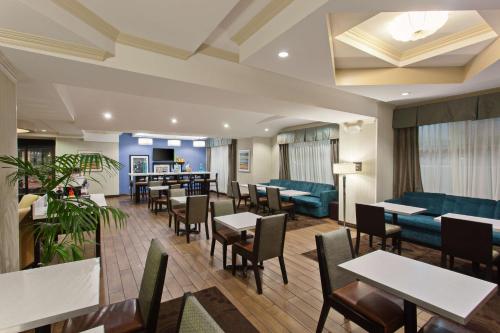 a restaurant with tables and chairs and a couch at Hampton Inn Los Angeles Int'l Airport/Hawthorne in Los Angeles