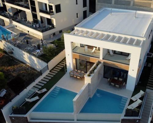 an aerial view of a house with a swimming pool at Villa Rosemary in Makarska