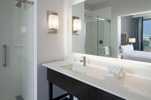 a bathroom with a sink and a large mirror at Homewood Suites By Hilton Los Angeles International Airport in Los Angeles