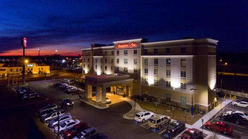 a hotel with cars parked in a parking lot at Hampton Inn Lumberton, NC in Lumberton