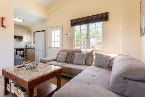 a living room with a couch and a table at Villa Amorosa in Neo Chorio