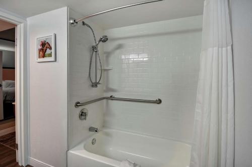 a bathroom with a white tub and a shower at Hampton Inn Lexington I-75 in Lexington