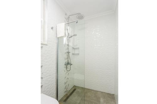 a shower with a glass door in a bathroom at Villa Portakal Blossom in Dalyan