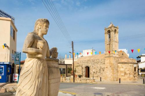 a statue of a woman standing in front of a building at Villa Xenios Dias in Argaka