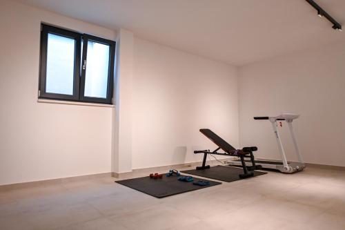 an empty room with a treadmill and a window at Villa Rosemary West in Makarska