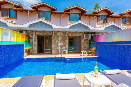 a villa with a swimming pool in front of a house at Villa Ayla Paradise in Dalyan