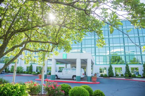 a white van parked in front of a building at Embassy Suites by Hilton Lexington Green in Lexington
