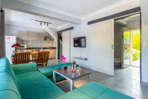 a living room with a blue couch and a table at Villa Ayla Paradise in Dalyan