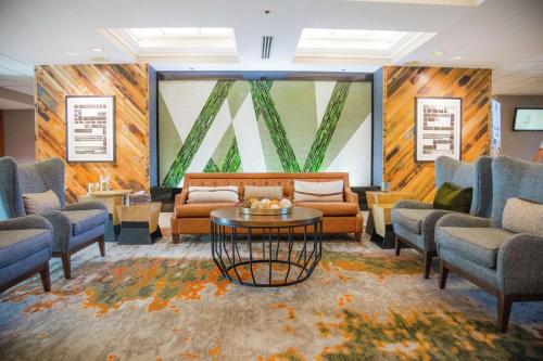 a waiting room with couches and a table at Embassy Suites by Hilton Lexington Green in Lexington
