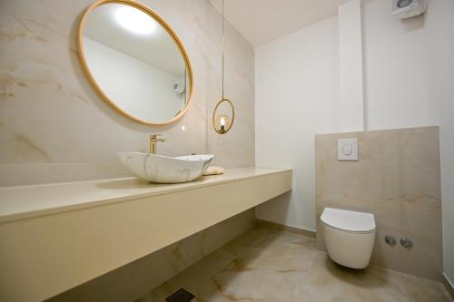 a bathroom with a sink and a mirror at Villa Rosemary West in Makarska