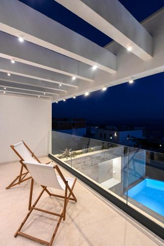 a chair and a swimming pool on the roof of a building at Villa Rosemary West in Makarska
