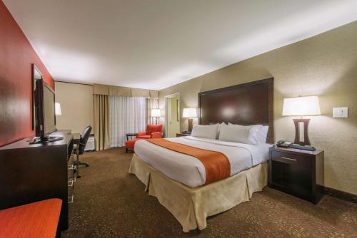 a hotel room with a large bed and a television at Hotel MTK Mount Kisco in Mount Kisco