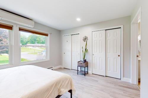 a bedroom with a large bed and a window at Cozy Family Home in Penn Yan