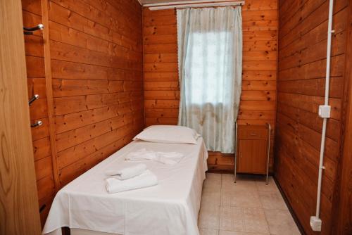 a small room with a bed and a window at Village of Peace - House 39 in Shkodër