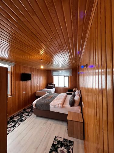 a bedroom with a bed with a wooden ceiling at Panorama Otel in Uzungol
