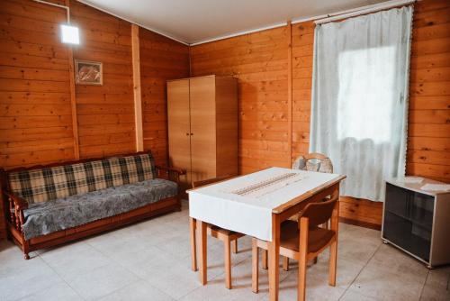 a living room with a table and a couch at Village of Peace - House 39 in Shkodër
