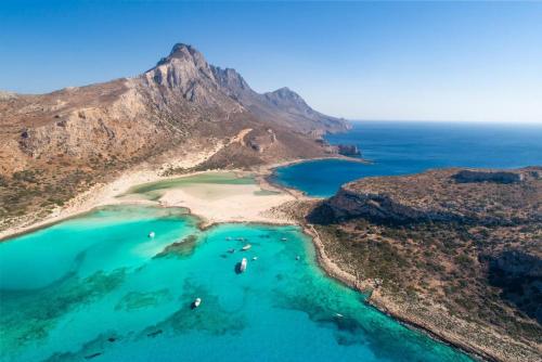 an aerial view of a beach with turquoise water at Neria Villas Collection in Áptera