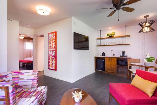 a living room with a red couch and a table at Hilton Garden Inn Kauai Wailua Bay, HI in Kapaa