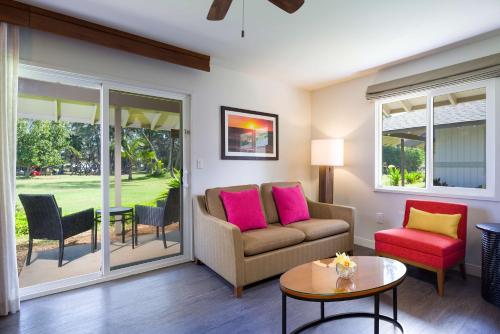 a living room with a couch and a table at Hilton Garden Inn Kauai Wailua Bay, HI in Kapaa