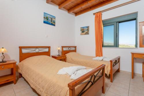 A bed or beds in a room at Spiros Villas Collection