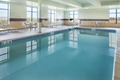 a swimming pool with blue water in a building at Hampton Inn and Suites - Lincoln Northeast in Lincoln