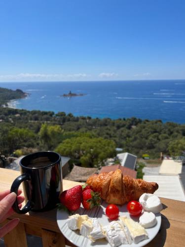 a plate of food with strawberries and a cup of coffee at Mobile Evasion okpl BEAUVOIR in Saint-Raphaël