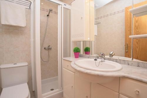 a bathroom with a sink and a shower at Villa Alicia in Portocolom