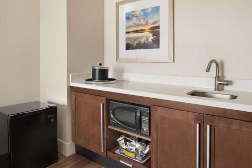 a kitchen with a sink and a microwave at Hampton Inn Lawrence in Lawrence