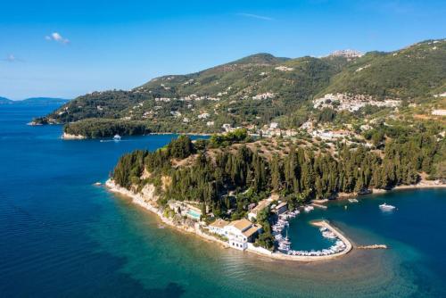 an island in a body of water with trees at Effie Apartment in Ágios Stéfanos