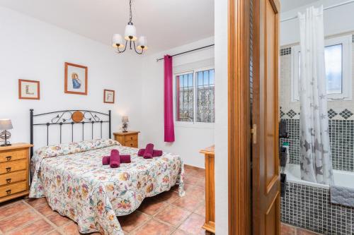 una camera con letto e vasca da bagno di Villa Cortijo Martin a Frigiliana