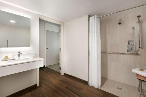 a bathroom with a sink and a shower at DoubleTree by Hilton McLean Tysons in Tysons Corner