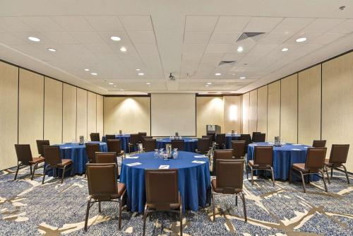 a conference room with blue tables and chairs at Embassy Suites by Hilton Orlando Downtown in Orlando