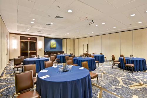 a conference room with blue tables and chairs at Embassy Suites by Hilton Orlando Downtown in Orlando