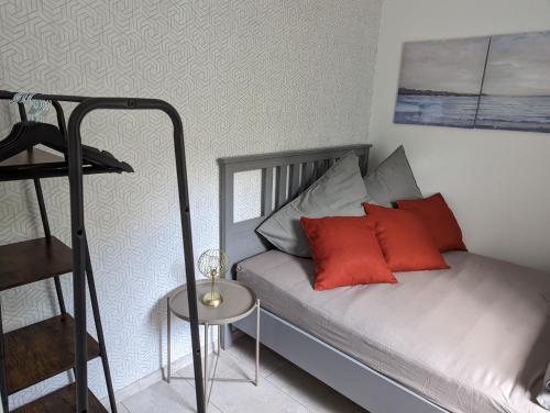 a bedroom with a bed with red pillows and a ladder at Möhne Traum, 120 m zum Möhnesee in Möhnesee