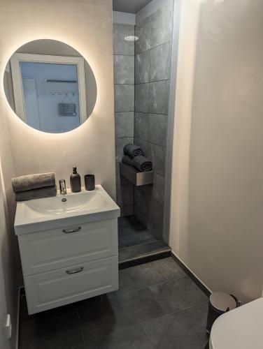 a bathroom with a white sink and a mirror at Möhne Traum, 120 m zum Möhnesee in Möhnesee