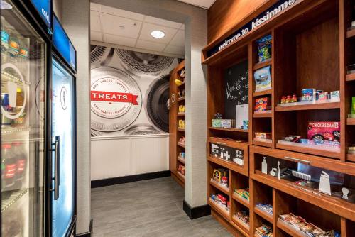 a grocery store aisle with a treats sign on the wall at Hampton Inn & Suites Orlando-South Lake Buena Vista in Kissimmee