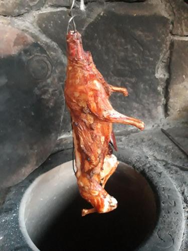 a piece of meat is hanging from a bucket at Old Byurakan Gouest House in Byurakan
